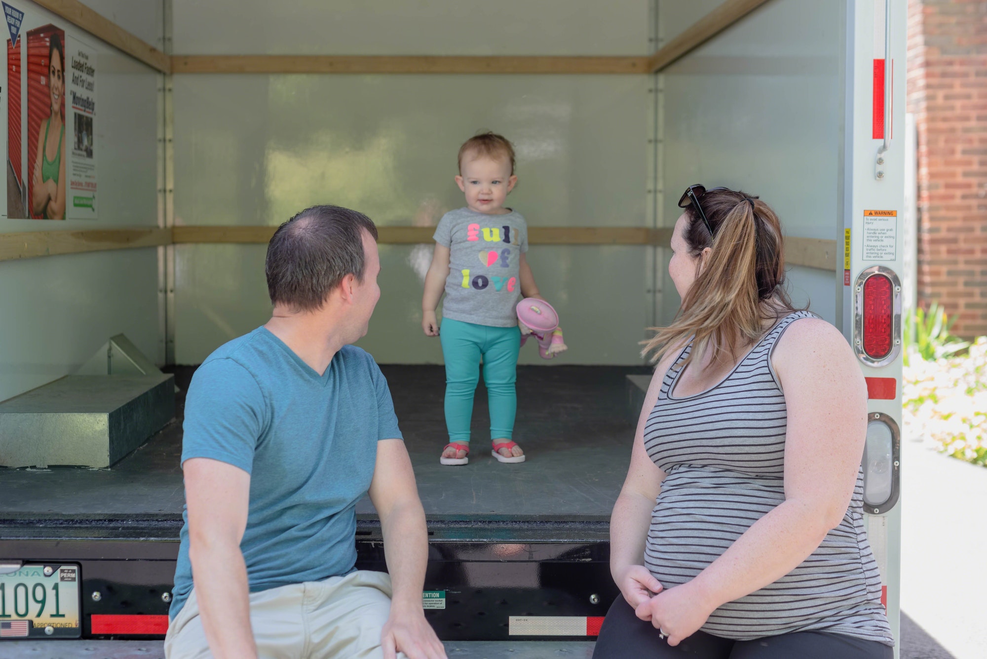 Young family with rental truck on moving day